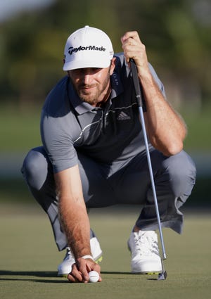 Dustin Johnson lines up his ball on the 14th green during the second round.