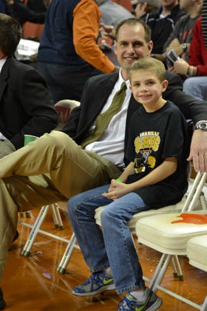Cooper Pillion, right, sits with his dad, AHS coach Jason Pillion, before the start of Thursday's semifinal game.