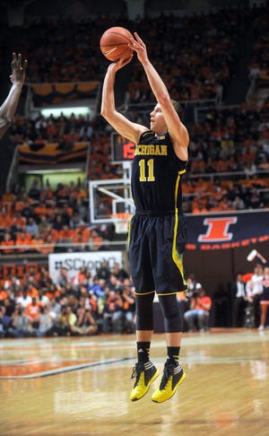 Michigan guard Nik Stauskas goes up with a 3-point shot in the second half in an NCAA college basketball game against Illinois on Tuesday, March 4, 2014, in Champaign, Ill. Michigan won 84-53. (AP Photo/Rick Danzl)