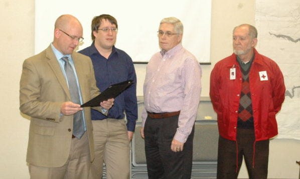 Mayor Stephen Haynes, left, reads a proclamation declaring March as American Red Cross Month. Local Red Cross representatives, beginning second from left, Joshua McDowell, Gene Deason, and John Gooch, were present for the reading.