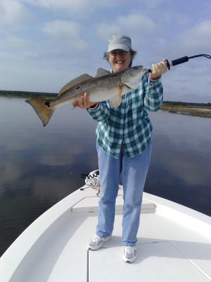 Linda Vickers shows off a 29-inch redfish caught just before the last cold front moved through the area.