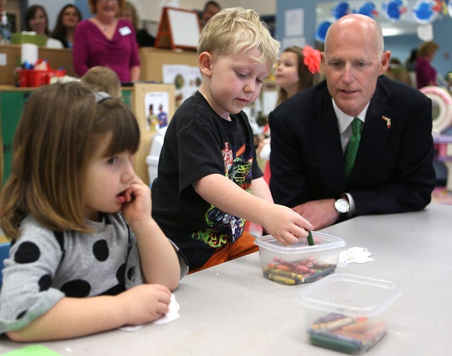Gov. Rick Scott meets Mali Pipkin, left, and Jacob Hudson, middle, at the Science and Discovery Center of Northwest Florida on Wednesday in Panama City.