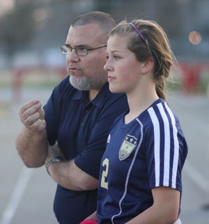 Northside girls’ soccer coach Jeff Cobb talks to freshman Amanda MacFarlane during the Monarchs’ 7-1 loss at Jacksonville on Tuesday night. Northside is off to a 2-2-1 start to the season while having to play without reigning leading scorer Ashleigh Fairow, who suffered a knee injury in the offseason. Fairow was also The Daily News’ offensive player of the year last season.