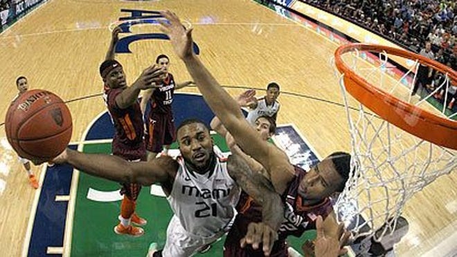 GREENSBORO, NC - MARCH 12: Erik Swoope #21 of the Miami Hurricanes drives to the basket against Trevor Thompson #32 of the Virginia Tech Hokies during the first round of the 2014 Men's ACC Basketball Tournament at Greensboro Coliseum on March 12, 2014 in Greensboro, North Carolina. (Photo by Streeter Lecka/Getty Images)