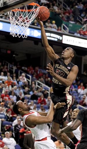 Florida State's Montay Brandon, top, runs into Maryland's Dez Wells, bottom, as he drives to the basket during the second half of a second round NCAA college basketball game at the Atlantic Coast Conference tournament in Greensboro, N.C., Thursday, March 13, 2014. (AP Photo/Bob Leverone)