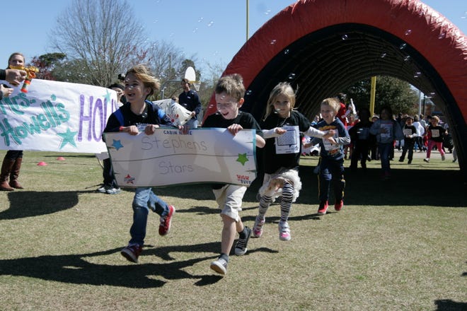 Kindergarten students, Kailen Scott and Alexander Shephard led the pack through the tunnel for Mrs. Stephen’s class at the fifth annual Boosterthon fundraiser on Thursday at Destin Elementary School. Funds from this year's event will go to support the technology program by way of new iPads for classroom technology stations
