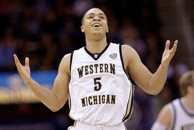 Western Michigan's David Brown reacts after making a three-point shot in overtime against Akron in an NCAA college basketball game at the Mid-American Conference tournament Friday, March 14, 2014, in Cleveland. Western Michigan defeated Akron 64-60 in overtime. (AP Photo/Tony Dejak)