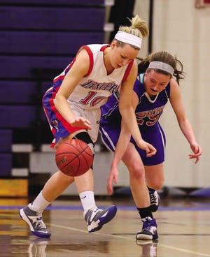 Winnacunnet’s Shauna Morrison, right, looks to steal the ball from Londonderry’s Aliza Simpson during Saturday’s Division I girls basketball quarterfinal.
