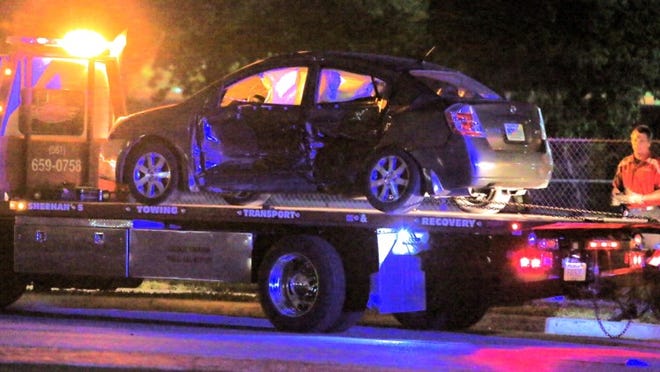 A car sits on a flatbed wrecker after an overnight wreck that closed westbound 45th Street in West Palm Beach.