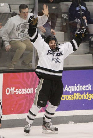 Matt Christie, of North Smithfield, pounds on the glass as he helps PC’s Derek Army celebrate the Friars’ second goal of the first period.