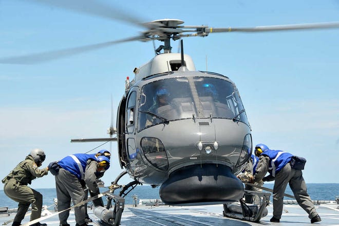 In this photo released by The Royal Malaysian Navy, a Royal Malaysian Navy Fennec helicopter prepares to depart to aid in the search and rescue efforts for the missing Malaysia Airlines plane over the Straits of Malacca, Malaysia, Thursday, March 13, 2014. Planes sent Thursday to check the spot where Chinese satellite images showed possible debris from the missing Malaysian jetliner found nothing, Malaysia's civil aviation chief said, deflating the latest lead in the six-day hunt. The hunt for the missing Malaysia Airlines flight 370 has been punctuated by false leads since it disappeared with 239 people aboard about an hour after leaving Kuala Lumpur for Beijing early Saturday. (AP Photo/The Royal Malaysian Navy)