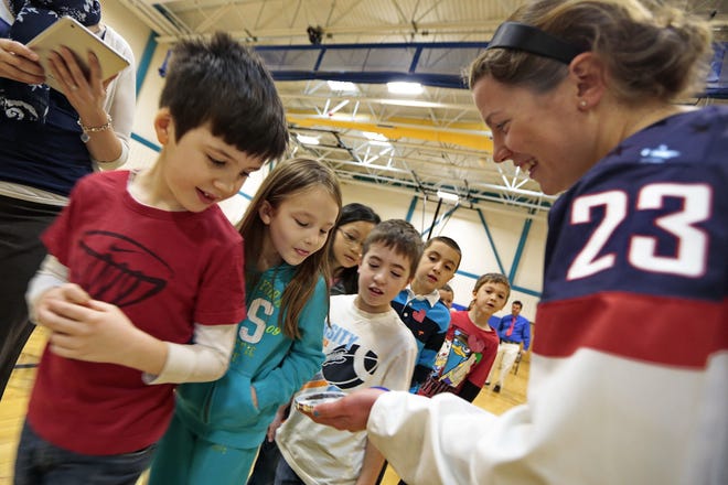 USA silver medal winning hockey player Michelle Picard shows students of the East Fairhaven School in Fairhaven her Olympic medal.