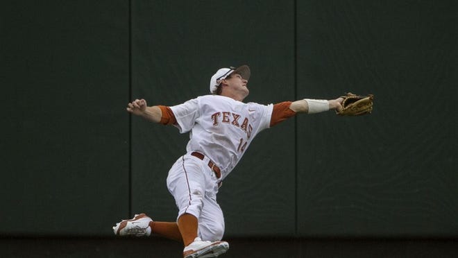 Texas’ Ben Johnson makes a diving catch to rob Kansas’ Dakota Smith of a hit.
