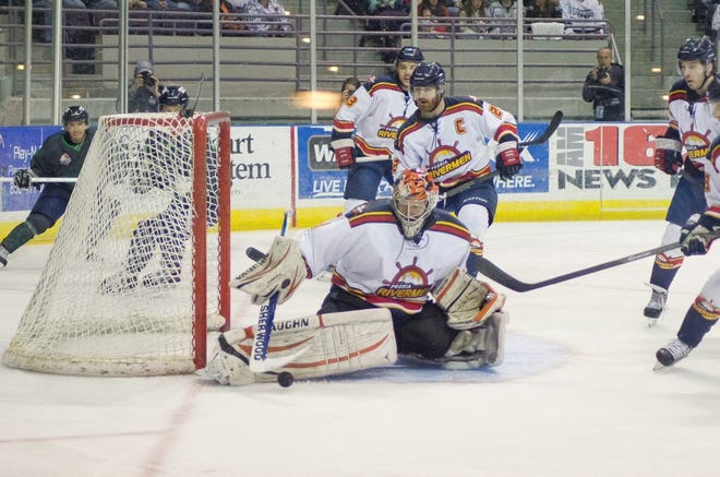 Rivermen rookie goaltender Kevin Carr makes one of his 39 saves while Peoria defensemen Cole Ruwe (2) and Charlie Carkin (23) assist during Peoria's 2-1 loss in an SPHL game at Pensacola Civic Center on March 15, 2014.