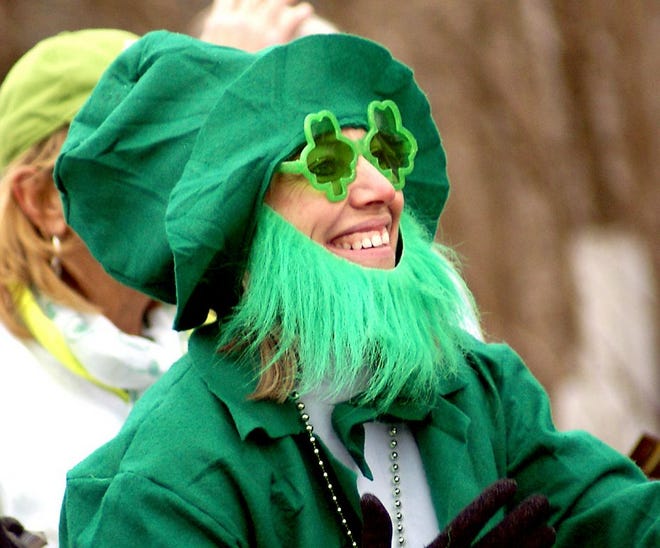 A leprechaun makes her way down Main Street in Horseheads during the St. Patrick's Day Parade.