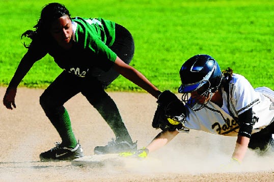 Millennium's Ericka Dominguez dives into second base ahead of the tag of McNair's Vanessa Trevino during Friday's high school softball game at Millennium.