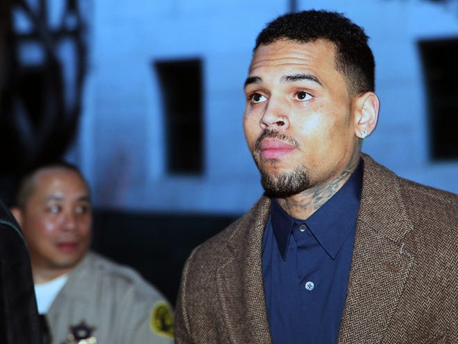 In this Feb. 3, 2014 file photo, R&B singer Chris Brown arrives at a Los Angeles Superior Court for a probation review hearing in Los Angeles. The Los Angeles Sheriff's Department said that Brown was arrested on an unspecified warrant on Friday, March 14, 2014. The 25-year-old singer remains on probation for his 2009 attack on then-girlfriend Rihanna and has been in court-ordered rehab for several months. (AP Photo/Nick Ut, file)