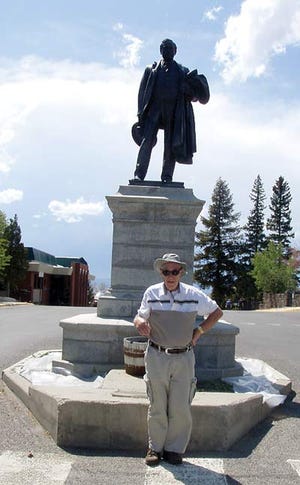Submitted photo - Harry Dunleavy, of Augusta, stands by the statue of Marcus Daly, who discovered a copper mine in Butte, Montana, which resulted in Irish immigrants settling in the area by the thousands.