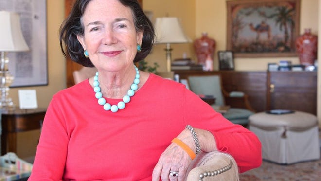 Mary Gushee, owner of the Mildred Hoit boutique on Sunrise Avenue, is organizing a shop and stroll event for May 3. Her goal is to raise $100,000 to pay for a two-year grant to a young scientist working to find better ways to screen or treat bladder cancer. She is wearing an orange band that signifies support of bladder cancer research.