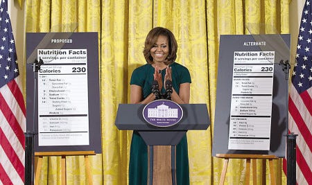 First lady Michelle Obama, flanked by enlargements of a proposed nutrition label, left, and a proposed alternate label, speaks about nutrition Feb. 27 in the East Room of the White House.