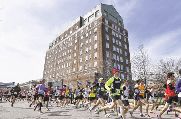 Runners move past the old New Bedford Hotel during start of the New Bedford half Marathon.