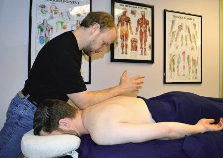 Scott Corliss, owner of Seacoast Orthopedic Massage treats a patient. Courtesy photo.