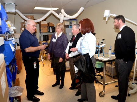 David Legault, facilities manager at Medtronic, left, shows some of the products manufactured at the company during a recent Tenants Association at Pease business after hours networking event held at Medtronic Advance Energy, which was also hosted by Sig Sauer Inc. Suzanne Laurent photo