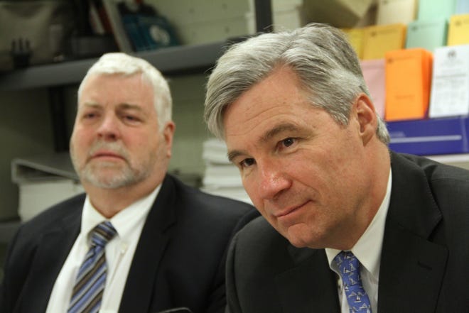 R.I. Department of Corrections Director A.T. Wall, left, listens as U.S. Sen. Sheldon Whitehouse holds a roundtable discussion on prison reform Monday in Providence.