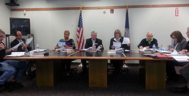 Members of the Metro board and Susan Duffy, Topeka Metropolitan Transit Authority general manager, discuss financial reports Monday.