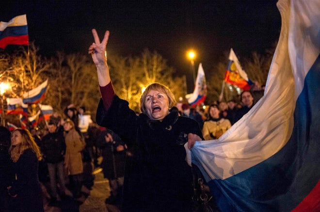 Pro-Russian people celebrate in the central square in Sevastopol, Ukraine, late Sunday.