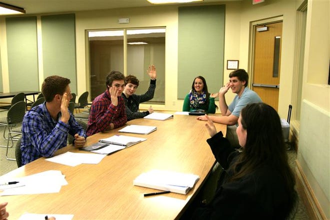 Youth Council functions just like the official City Council with votes on motions. Here the Youth Council votes on a motion to move the next meeting from its current date, during spring break, to an earlier date. Pictured from left are: Max Van Belkum, Andre Eimers, Adam Van Belkum, Erin Groth, Chandler Ankersen, and Megan Wood.