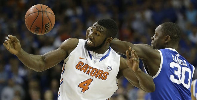 Center Patric Young, vying with Kentucky forward Julius Randle (30) for a loose ball during the SEC title game, and the Florida Gators could make the case for being one of the best teams in history with an NCAA title.