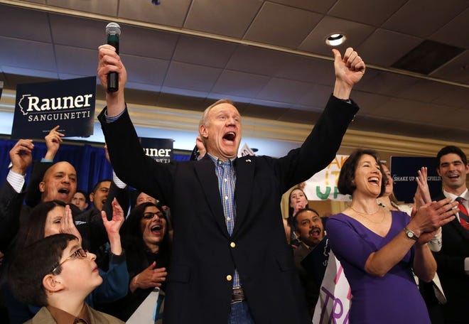 Businessman Bruce Rauner, left, and his wife Diana, right, celebrate with supporters Rauner becoming the Republican gubernatorial candidate after defeating the field of State Treasurer Dan Rutherford, State Sen. Kirk Dillard, and State Sen. Bill Brady, Tuesday, March 18, 2014, in Chicago. (AP Photo/Charles Rex Arbogast)