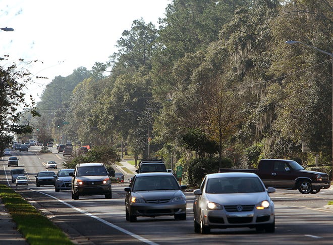 In this Dec. 21, 2013 file photo, traffic makes its way along Northwest 43rd Street in Gainesville. The Florida Legislature may reduce the state's vehicle registration fees.