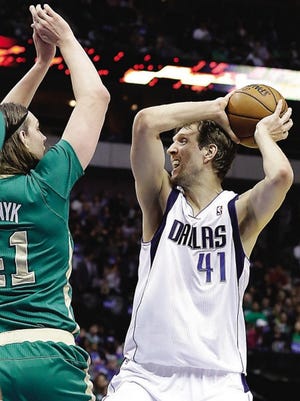 Dallas Mavericks forward Dirk Nowitzki (41) looks to pass against Boston Celtics center Kelly Olynyk (41) during their game Monday in Dallas.