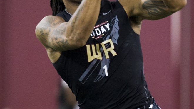 Former Florida State receiver Kelvin Benjamin catches a pass Tuesday during the school’s pro day in front of NFL scouts. FSU coach Jimbo Fisher said the best is yet to come from Benjamin, who’s entering the draft after his redshirt sophomore season. (AP Photo/Colin Hackley)