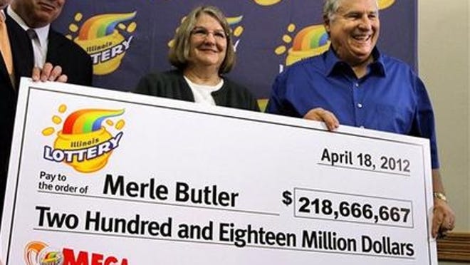 Merle and Patricia Butler, of Red Bud, Ill., pose with a novelty check during a news conference at the Red Bud Village Hall on Wednesday, April 18, 2012 in Red Bud, Ill. The retired southern Illinois couple has claimed the third and final share of last month's record $656 million Mega Millions jackpot. (AP Photo/Seth Perlman)