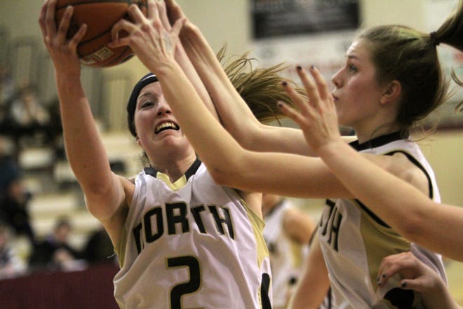 North Kingstown teammates Taylor Buckley, left, and Kristjana McCarthy battle each other for a rebound in their semifinal game against La Salle on Tuesday night.
