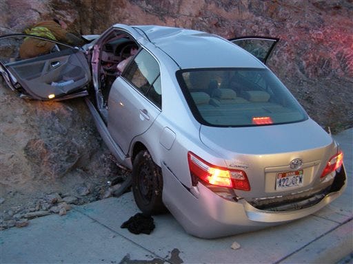 n this Nov. 5, 2010 file photo released by the Utah Highway Patrol, a Toyota Camry is shown after it crashed as it exited Interstate 80 in Wendover, Utah. Police suspect problems with the Camry's accelerator or floor mat caused the crash that left two people dead and two others injured. The Wall Street Journal is reporting Wednesday March 19, 2014 the U.S. Justice Department may reach a $ 1 billion settlement with Toyota Motor Corp., ending a four-year criminal investigation into the Japanese automaker's disclosure of safety problems.