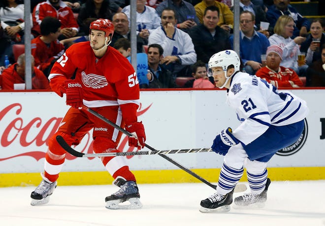 Detroit Red Wings defenseman Jonathan Ericsson (52), of Sweden, defends Toronto Maple Leafs left wing James van Riemsdyk (21) in the second period of an NHL hockey game in Detroit, Tuesday, March 18, 2014. (AP Photo/Paul Sancya)