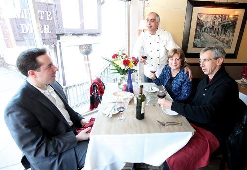 Photo by Marie Dirle/New Jersey Herald - Sam Masih, owner of Tanti Baci Restaurant, back center, chats with Michael Natale, left, Judith Natale, center, and Tom Laskow, all of Sparta.