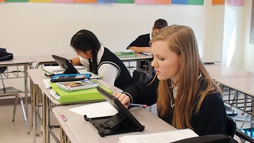 Photo by Greg Watry/New Jersey Herald - Eighth-graders Bridget Murphy and Alyssa Talon, of Pope John, use the iPad during classroom work. Last year all Pope John’s eighth-grade students began using the iPad.