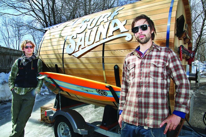 Surfers and craftsmen Tyler Sauter, left, and Ross Beane stand with their new creation, the mobile Surf Sauna created at the Port City Makerspace in Portsmouth.