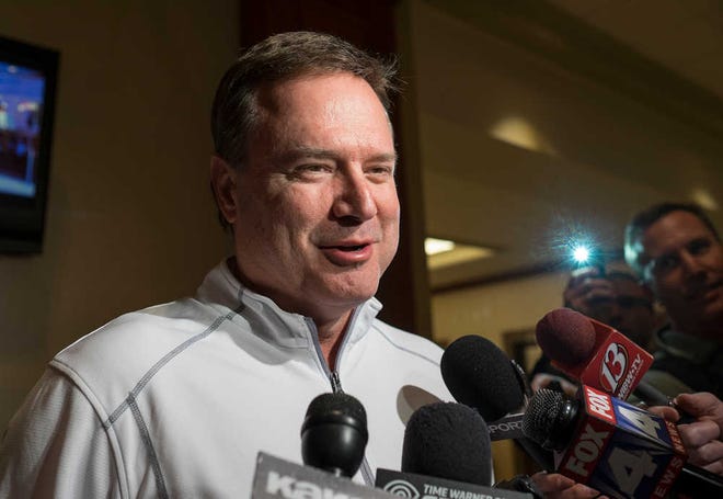 Coach Bill Self talks with the media after arriving at the team hotel in St. Louis on Wednesday evening. Self told reporters gathered for the NCAA Tournament games there that freshman center Joel Embiid would likely not play in any games this weekend.