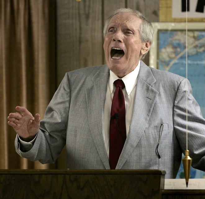 In this March 19, 2006 file photo, the Rev. Fred Phelps Sr. preaches at his Westboro Baptist Church in Topeka, Kan. Phelps, the founder of the Kansas church known for anti-gay protests and pickets at military funerals, died Thursday, March 20, 2014. He was 84.