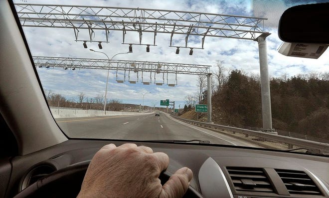While driving over the Sakonnet River Bridge, a toll is exacted as the vehicle and its transponder, seen in the top right corner of this picture, beneath the rearview mirror, pass beneath the overhead sensors.