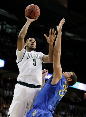 Michigan Stateís Adreian Payne (5) shoots over Delawareís Carl Baptiste (33) in the first half in Spokane, Wash. on Thursday. (AP Photo/Young Kwak)