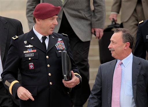 Brig. Gen. Jeffrey Sinclair, left, who admitted to inappropriate relationships with three subordinates, leaves court while talking with his defense attorney Richard Scheff, right, at Fort Bragg, N.C., Wednesday, March 19, 2014. Closing arguments were presented Wednesday, but no sentence was reached.