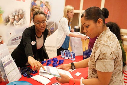 Sandra Karamba, MCCS Human Resources, talks with Cpl. Spendia Herrera about applying for jobs through MCCS during the resource fair at Marston Pavilion aboard Camp Lejeune Wednesday afternoon.