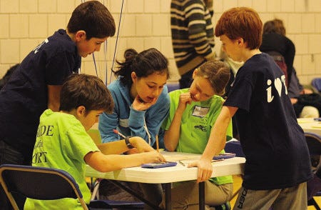 One of the math teams at the district math meet tries to solve a problem.